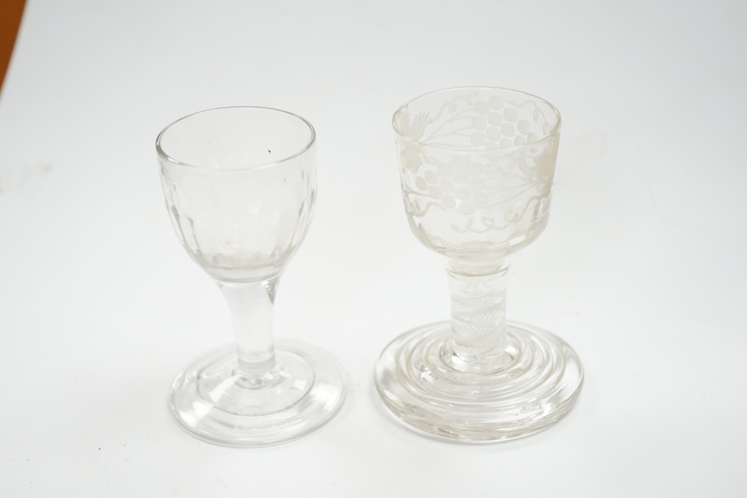 A mid 18th century firing glass with double series opaque twist stem and terraced foot, and another glass, tallest 9.5cm high. Condition - good